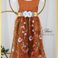 Burnt orange floral embroidery girls' dress. Sleeveless lace sleeves with a floral full length style. perfect for flower girls and special occasions. sizes for babies, toddlers and preteens. 