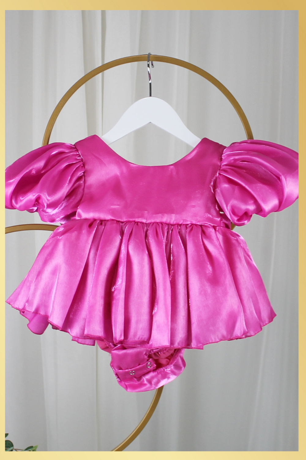 baby girl dress in fuchsia pink. Big puffy sleeves in romper style Organza shiny material. For first birthdays and flower girl dresses for weddings