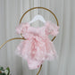 Back of light pink butterfly tulle dress on a hanger